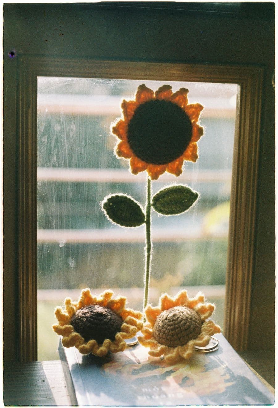 Handmade crochet sunflowers by a window