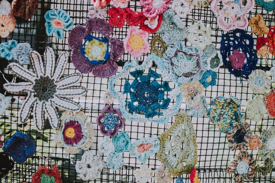 A display of colourful handmade crochet flowers
