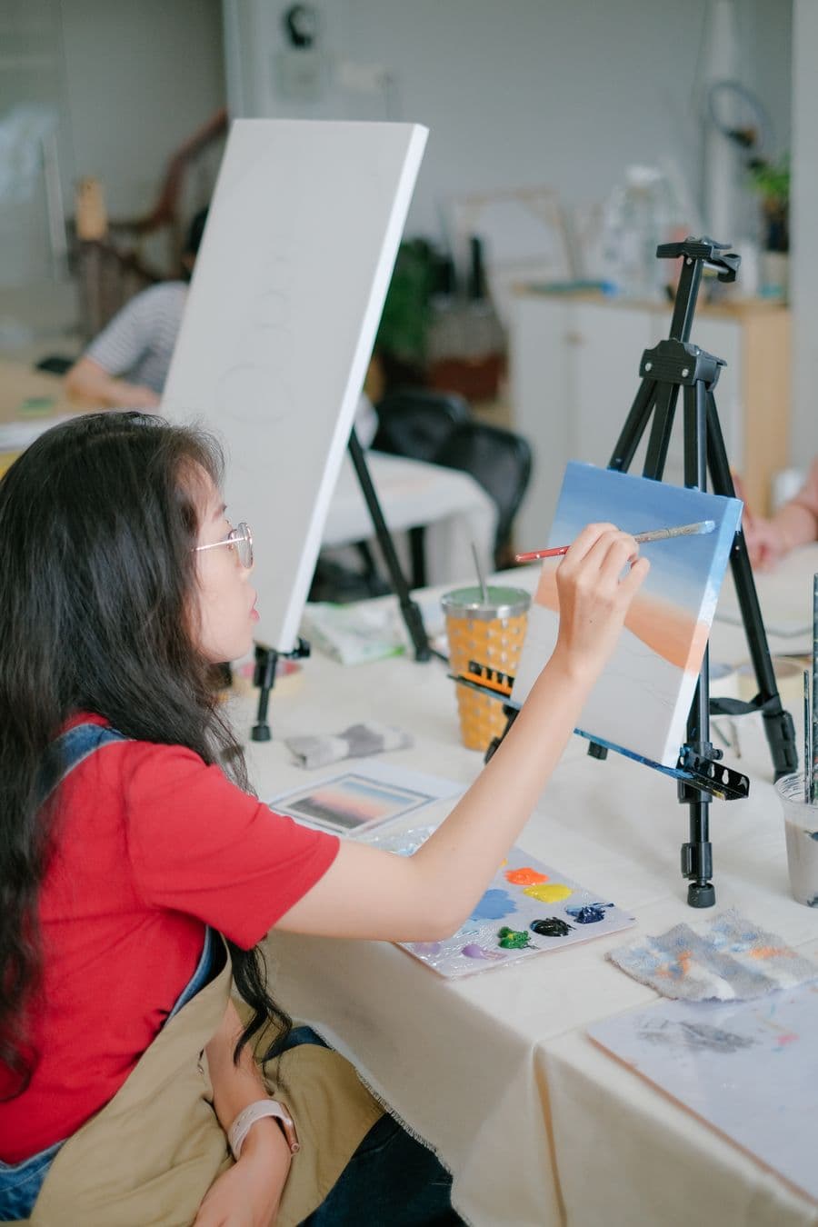 Artist hand-painting a canvas